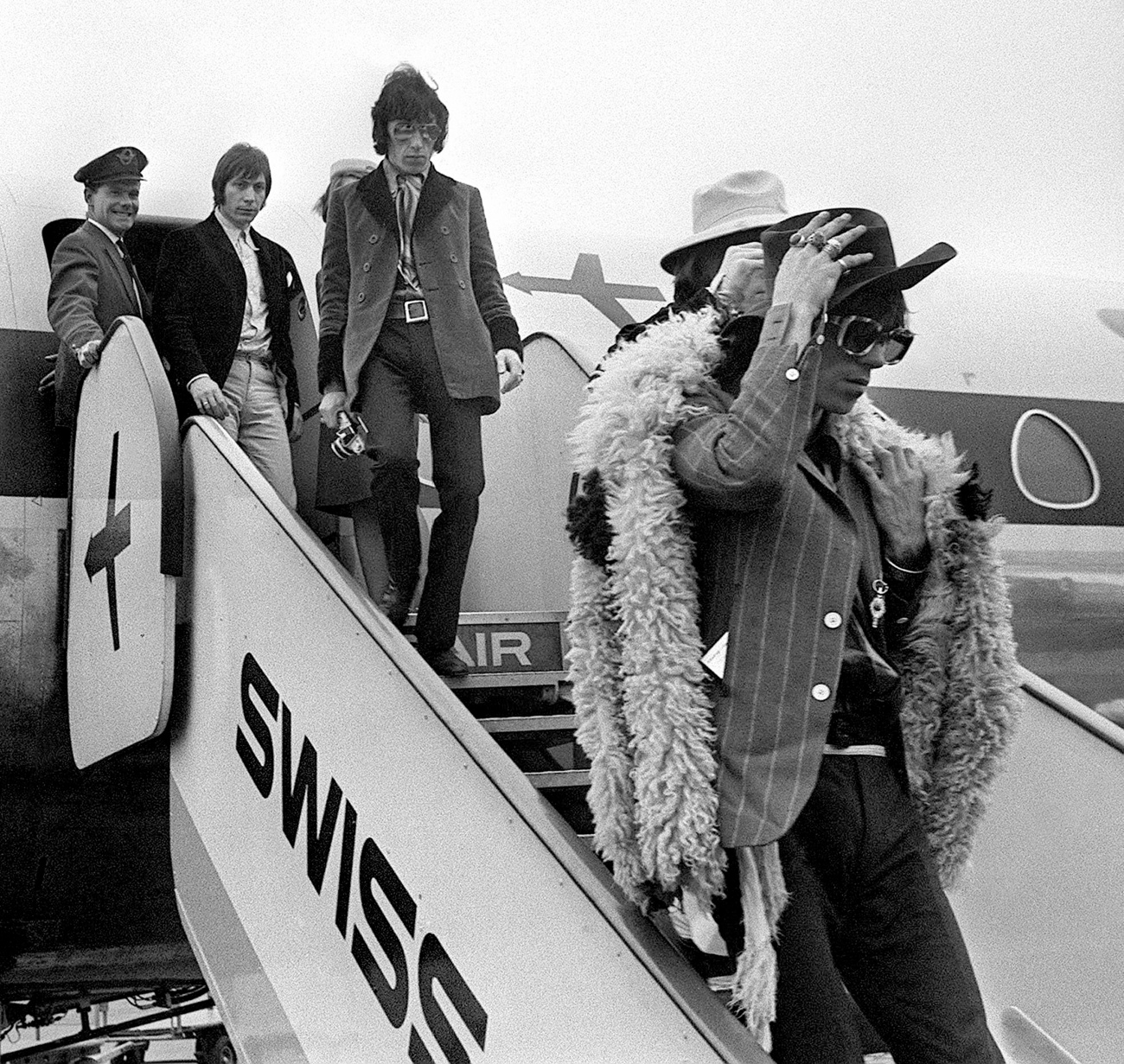 rolling stones members getting off plane