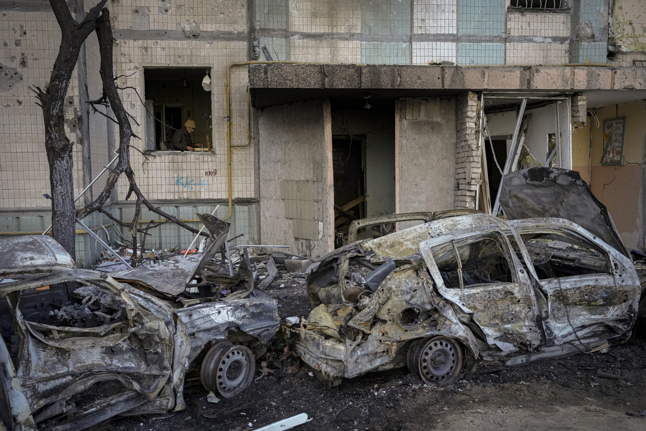 Burned out cars next to building in Kyiv.