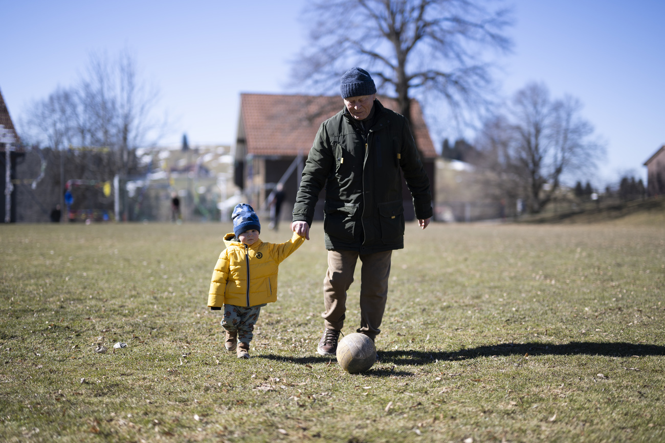 Old man and young child with ball