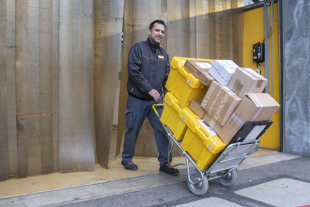 Post Office worker with trolley of parcels