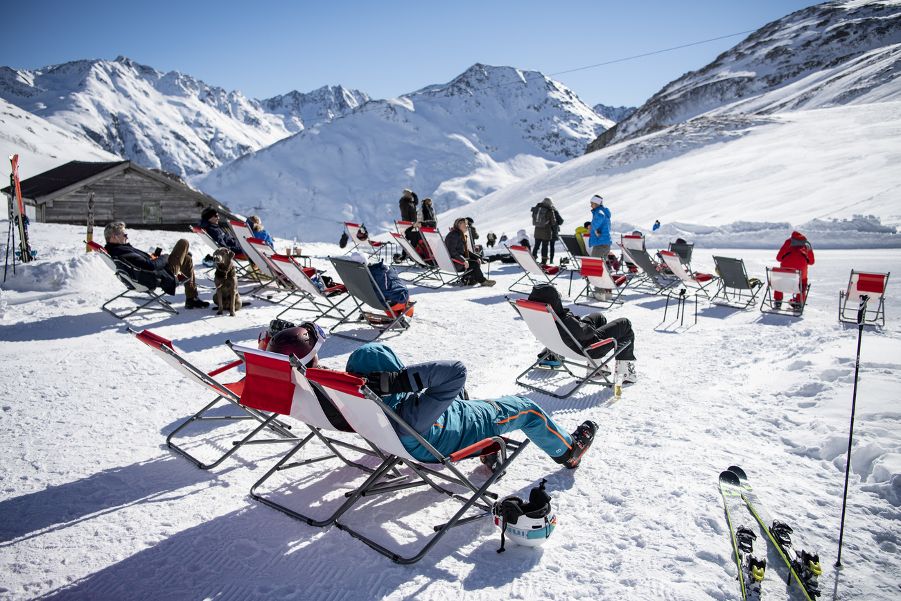 skieurs allongés sur des transats au soleil en Suisse
