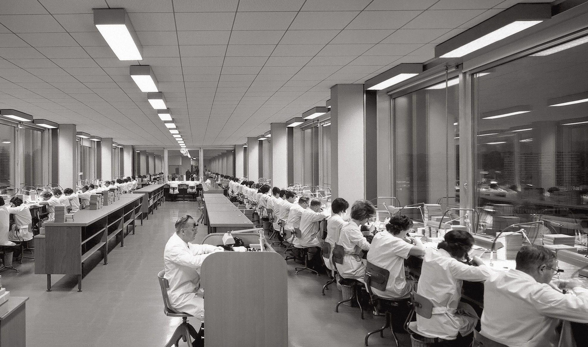 An assembly workshop at the Rolex world headquarters in Les Acacias, 1965.