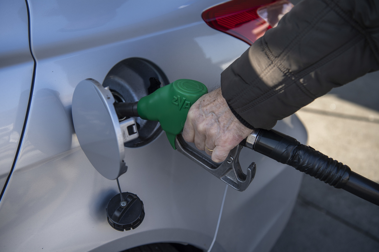 Man putting petrol in car.