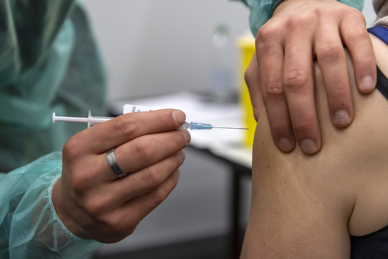 Man gives Covid injection to someone.