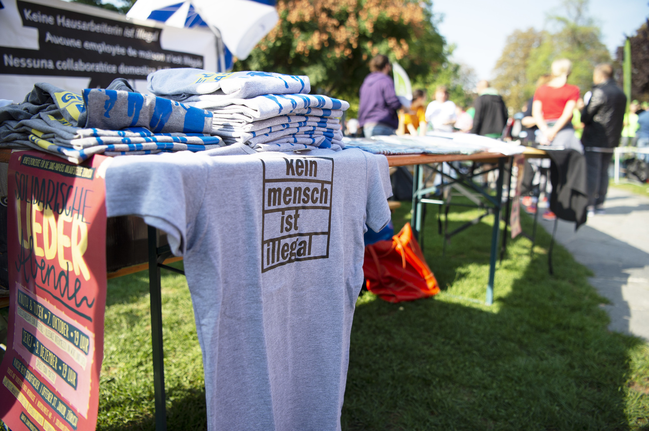 Stall with T-shirts with logo in German Nobody is illegal