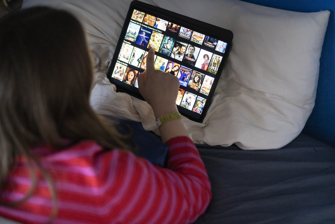 Young woman checking Netflix programme on her with tablet computer