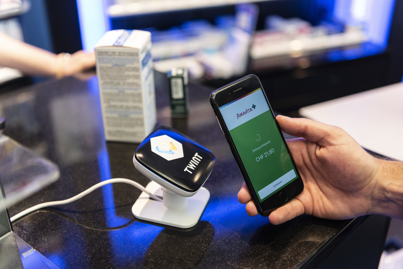A person uses the Twint cashless payment system via app on a smartphone.