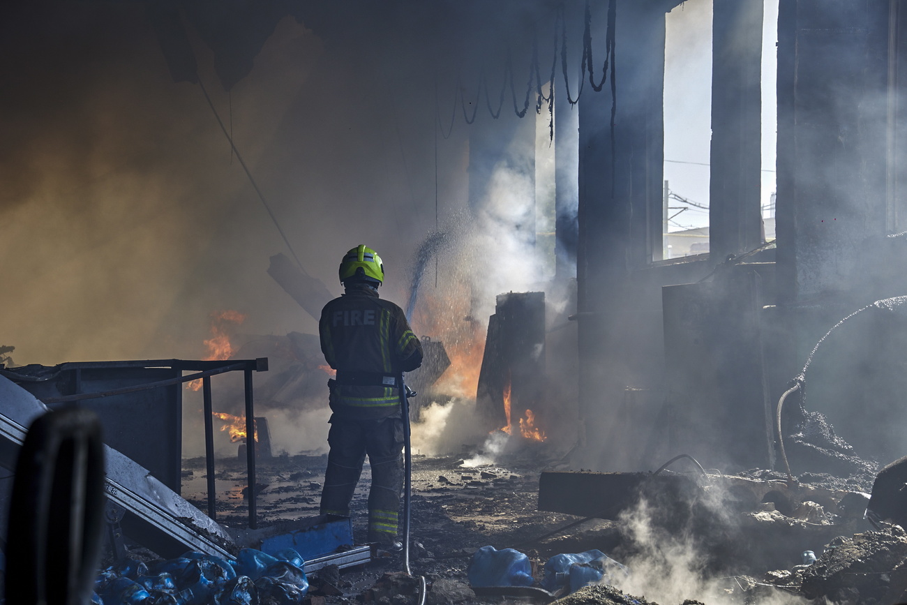 Fireman putting out fire after Russian shelling