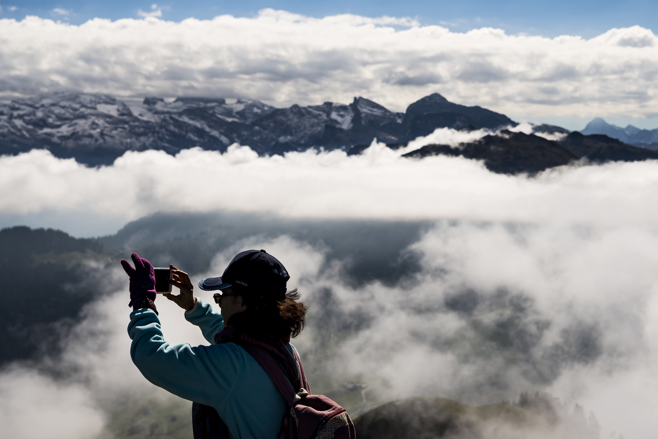Tourist taking a photo of a mountain.