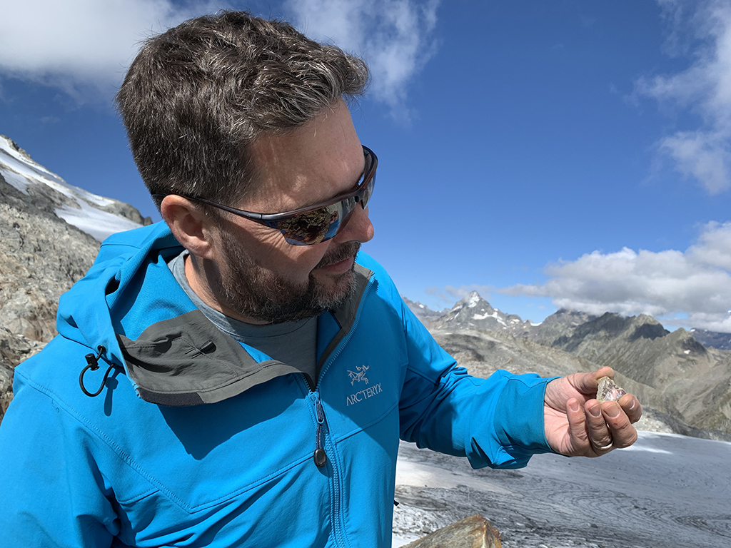 Man holding a triangular crystal