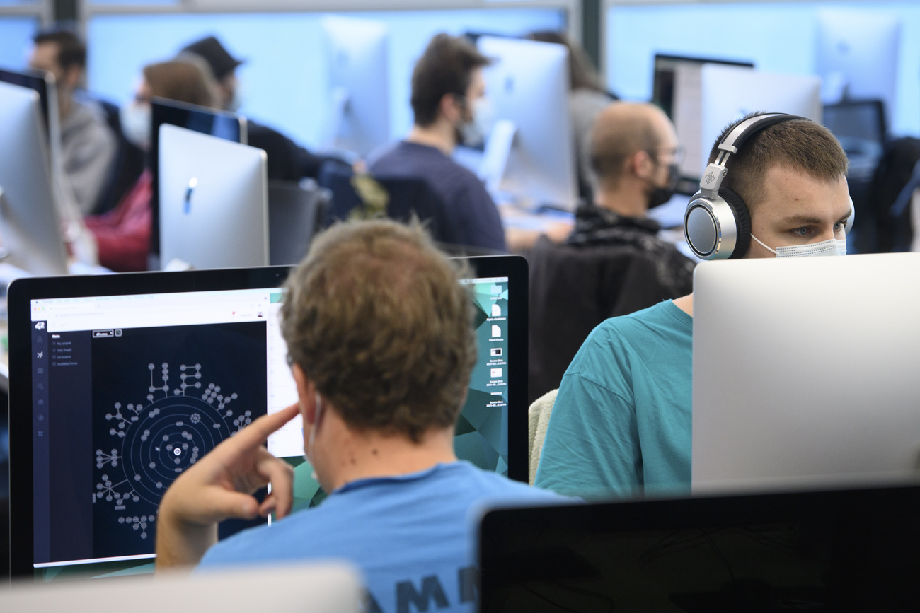 Informatikstudenten arbeiten in einem grossen Saal.