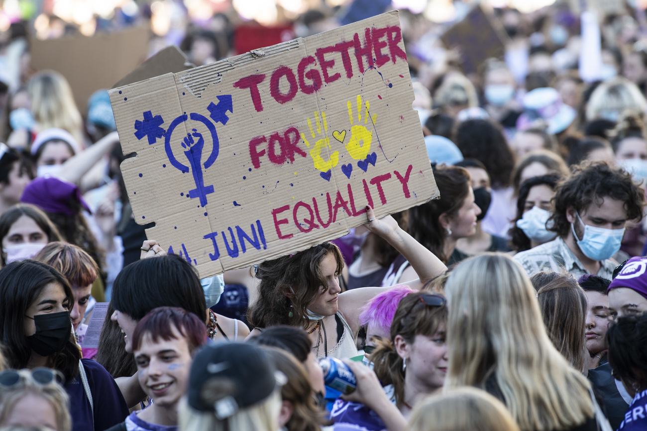 Women holding up panel calling for equal rights