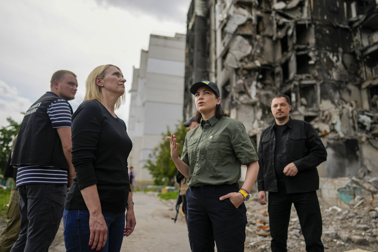 Ukraine Prosecutor General and group by destroyed building