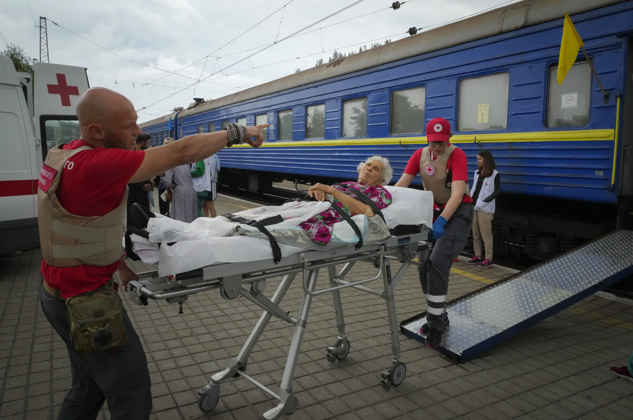 Une Ukrainienne âgée blessée évacuée sur un brancard