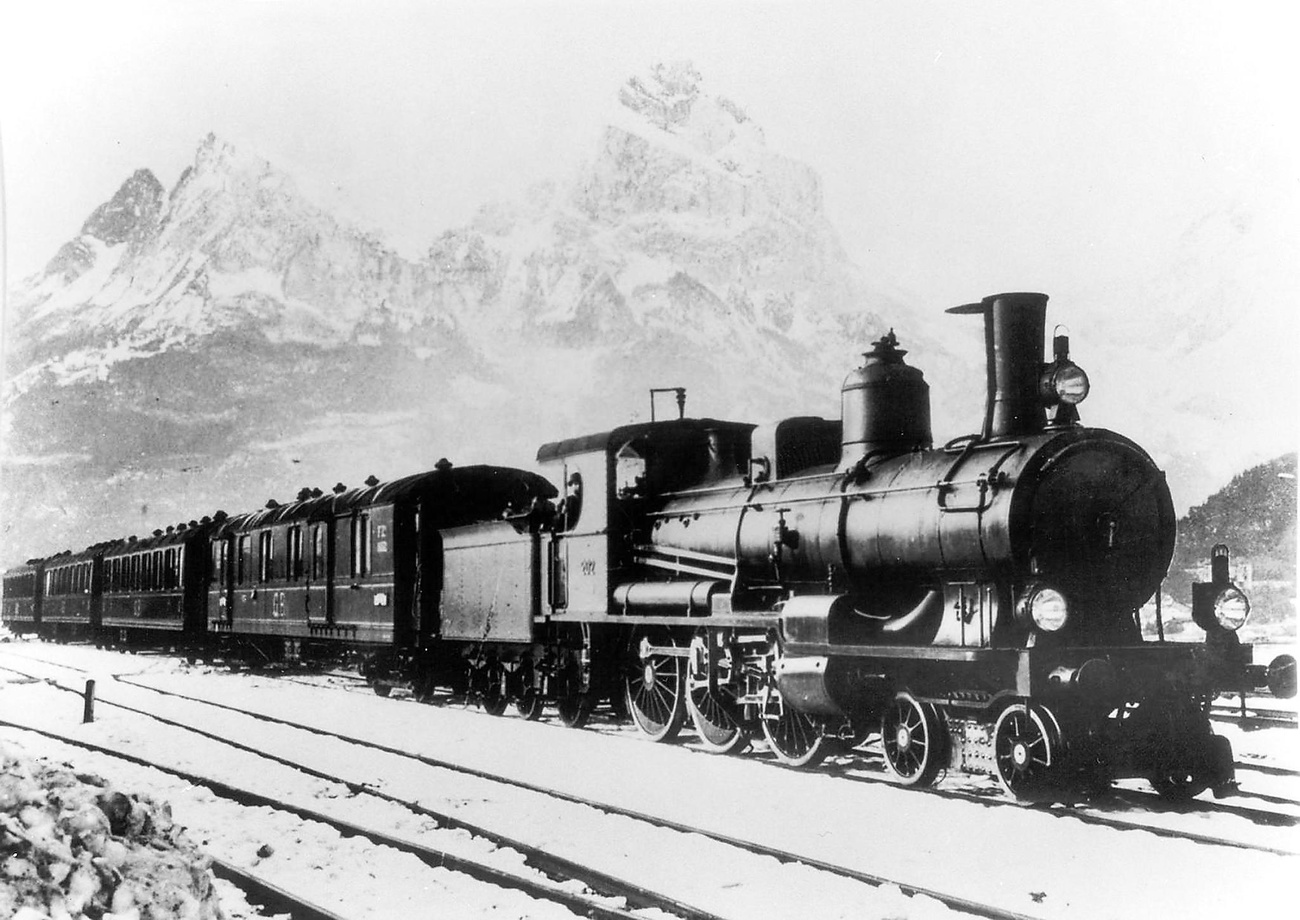 old photo of train in front of mountains