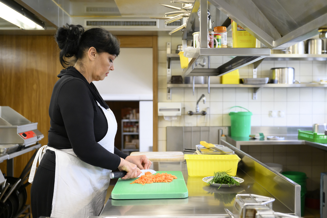 Refugee working in kitchen