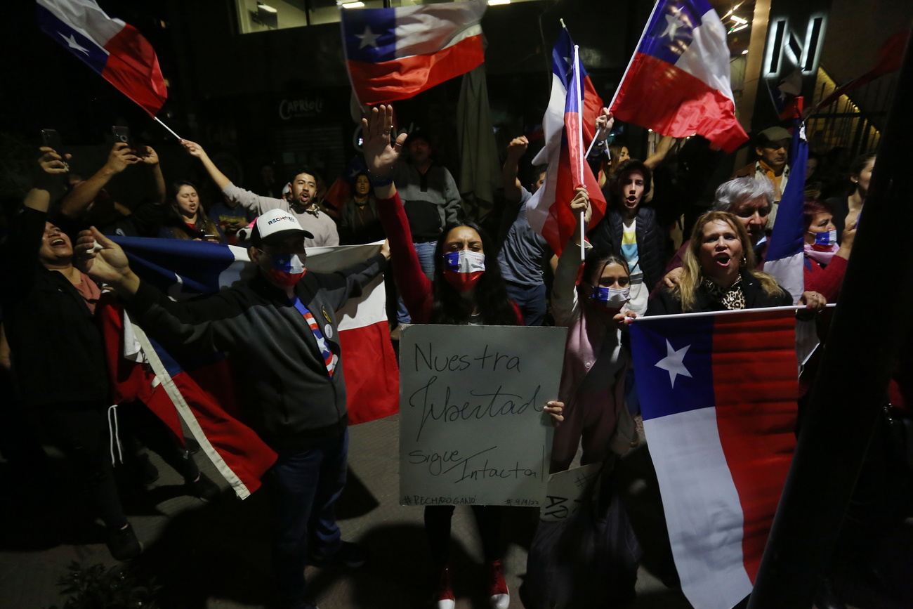 people and chilean flags