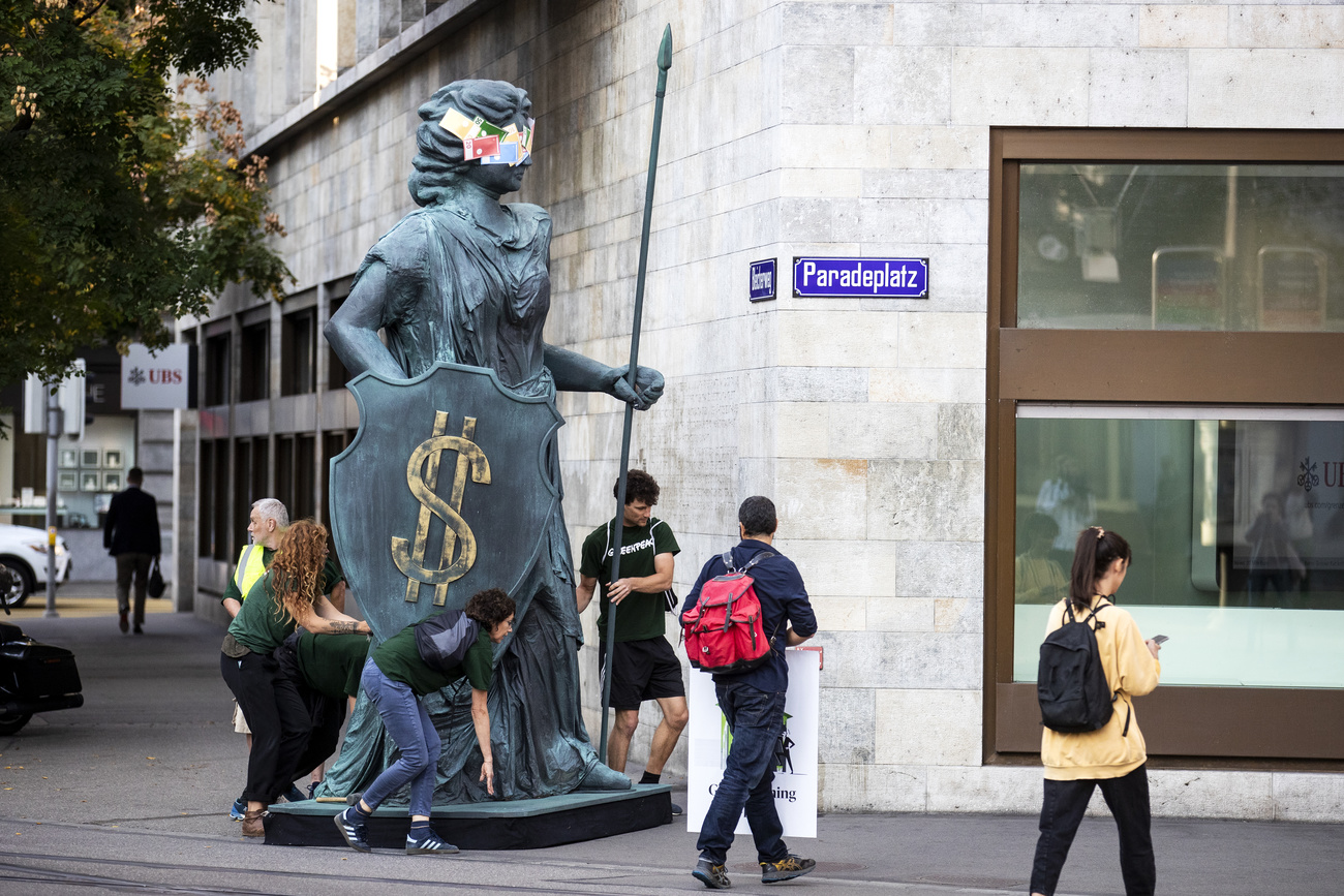 people in street statue with $ shield