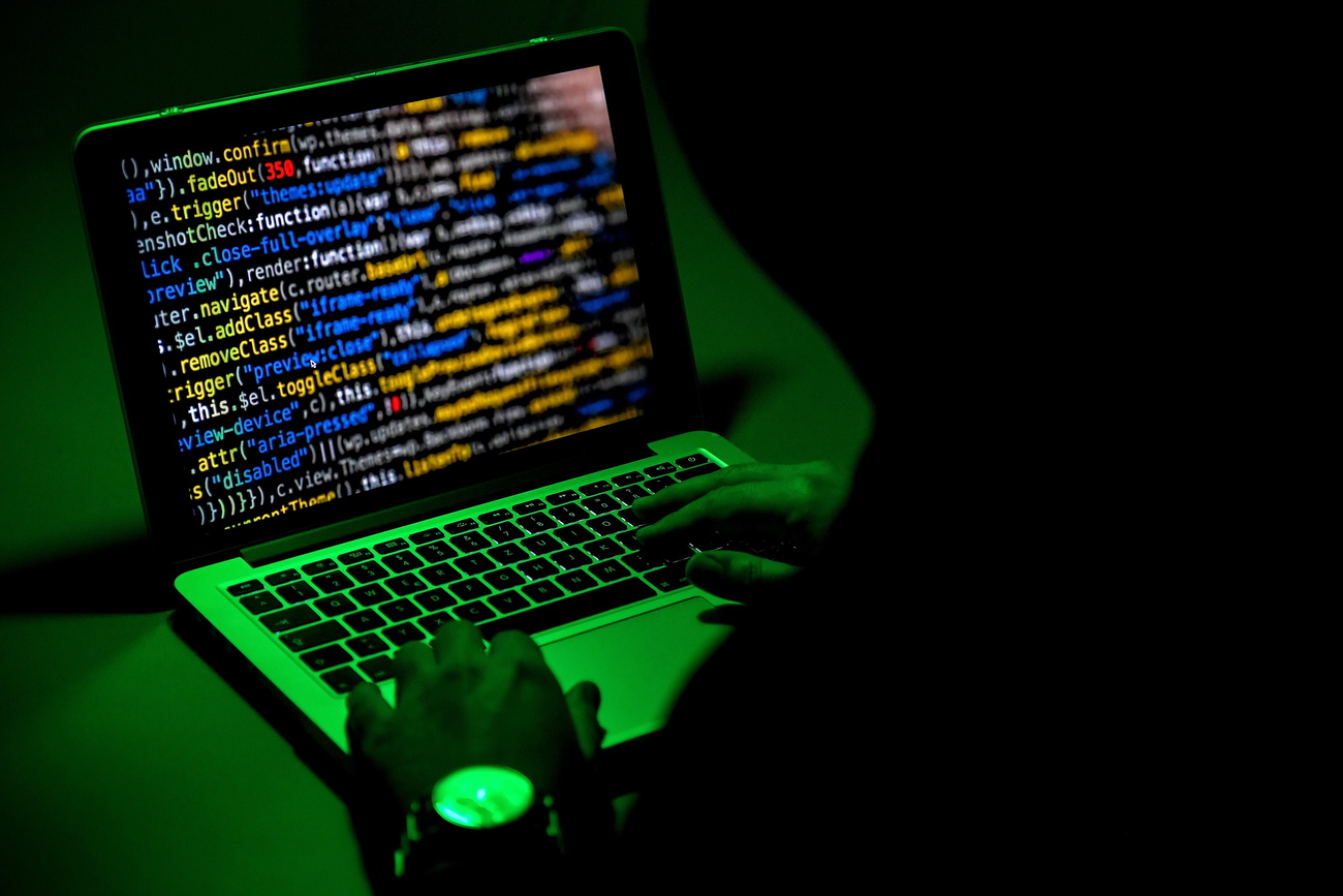 Shadowy figure at computer