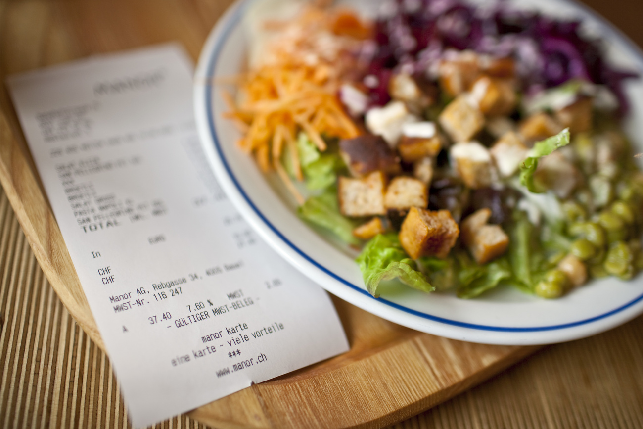 Restaurant bill sits next to plate of food