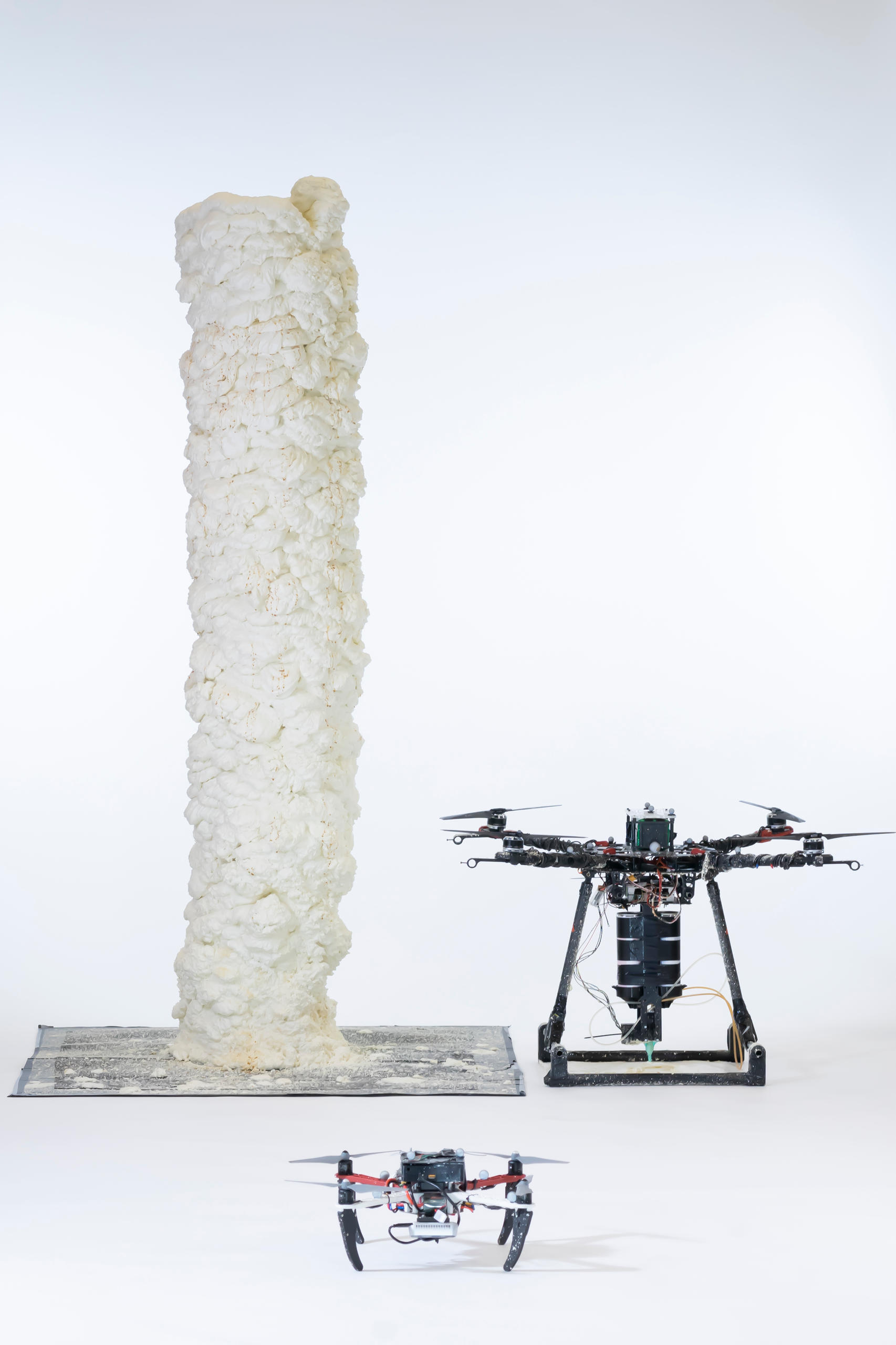 Drones worked together to build a two-metre-high tower of fast-hardening foam - layer by layer.