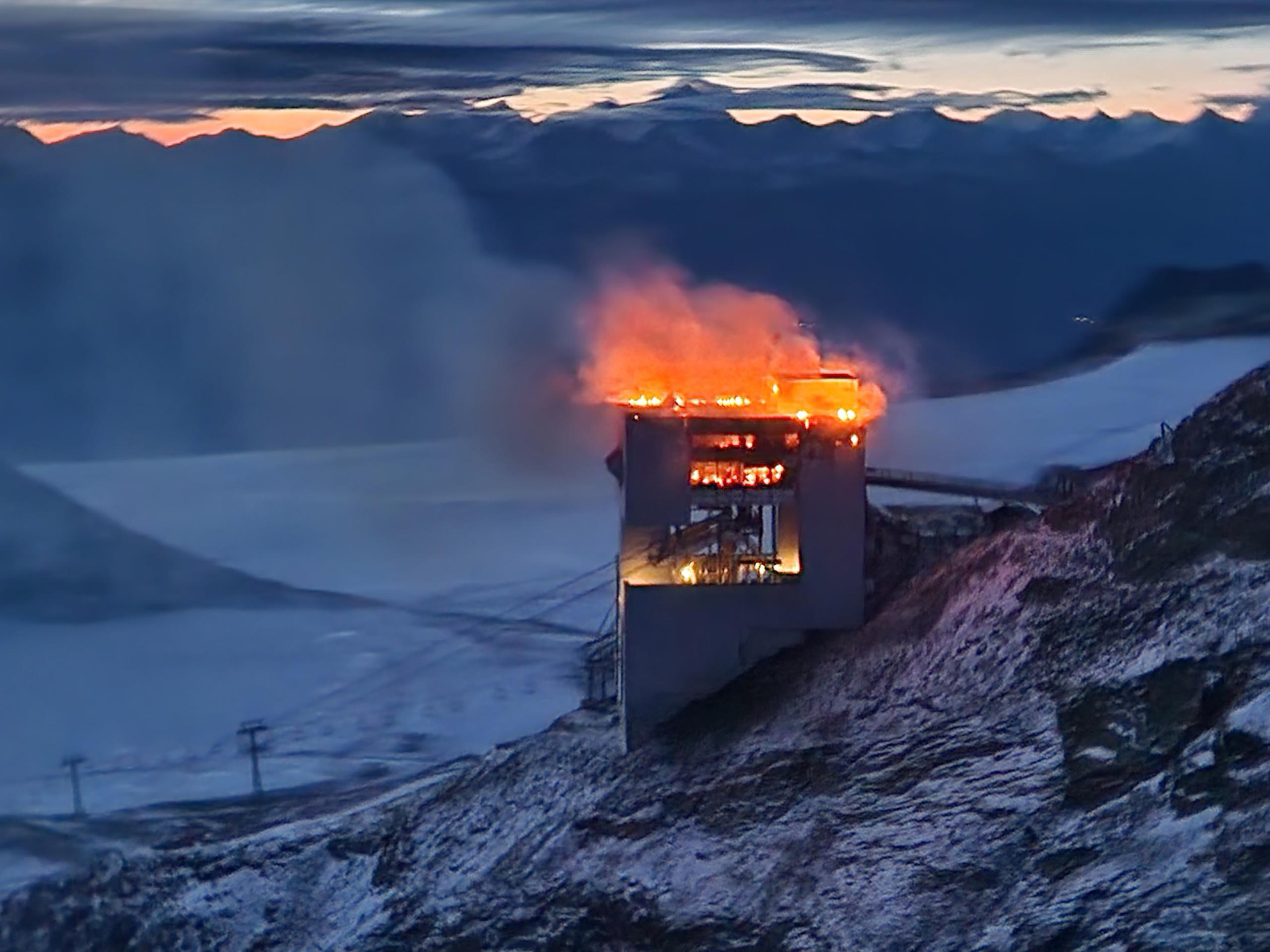 Flames burn the restaurant on a mountain top.