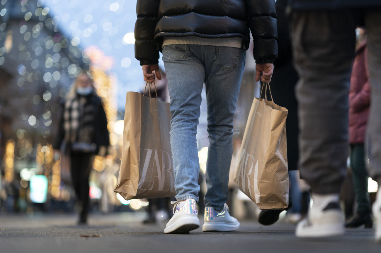 Person carrying shopping backs walks down high street