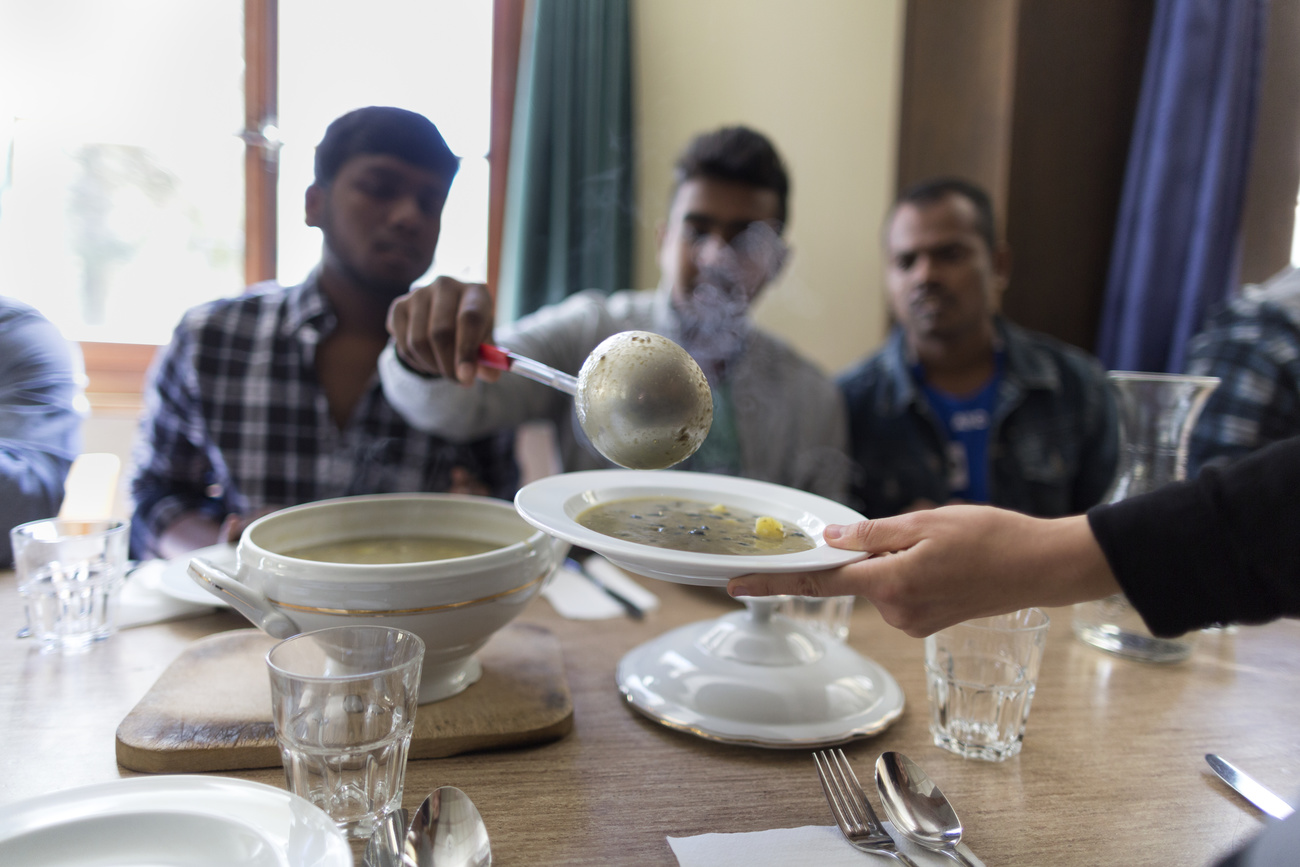 people at table ladling soup