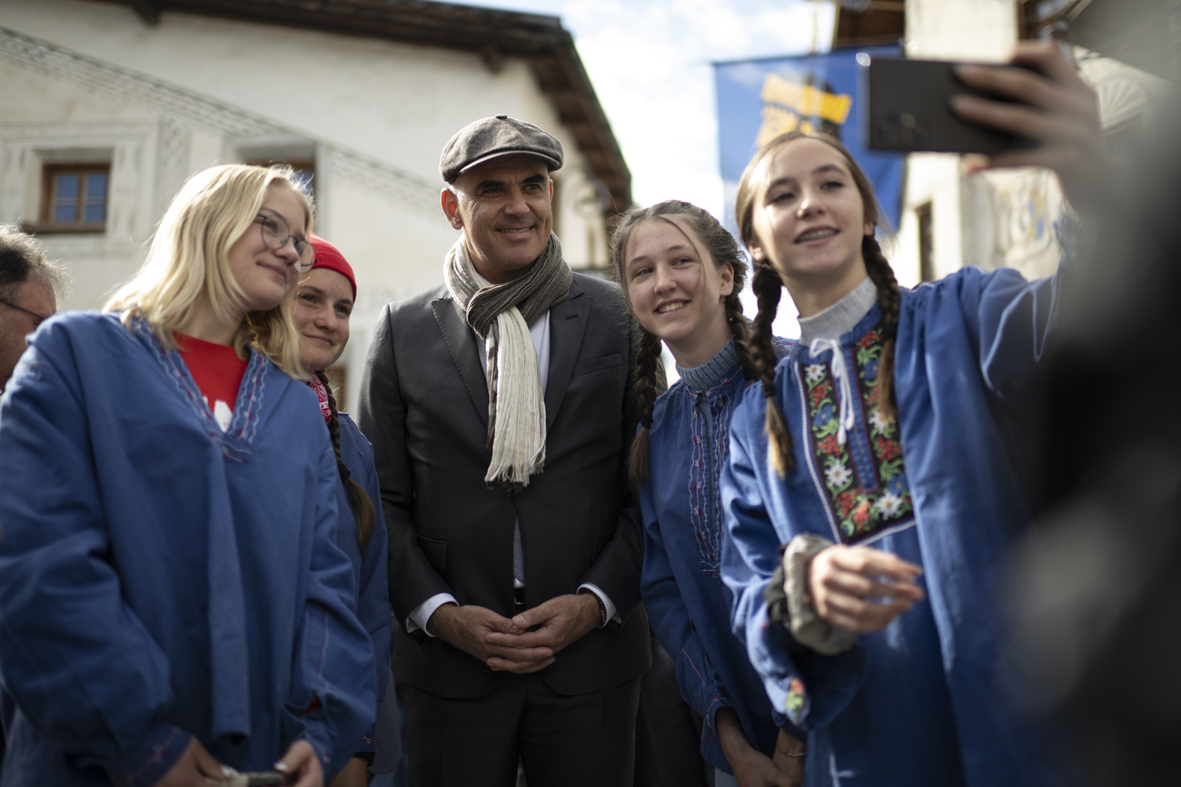 man with hat and young women in costumes