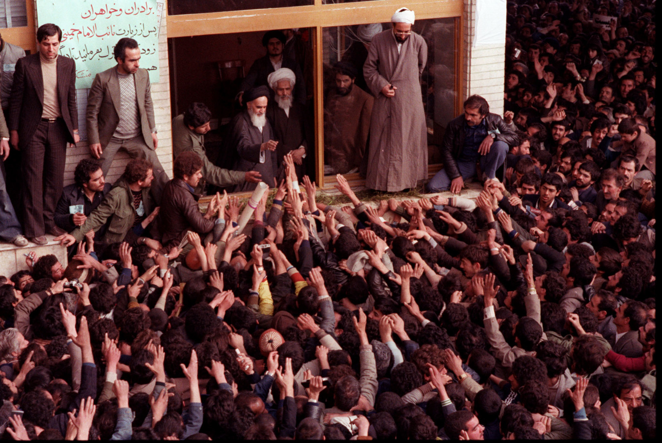 The late Ayatollah Ruhollah Khomeini, center, is greeted by supporters after arriving at the airport in Tehran Iran in this February 1, 1979 photo. (KEYSTONE/AP Photo/Str)