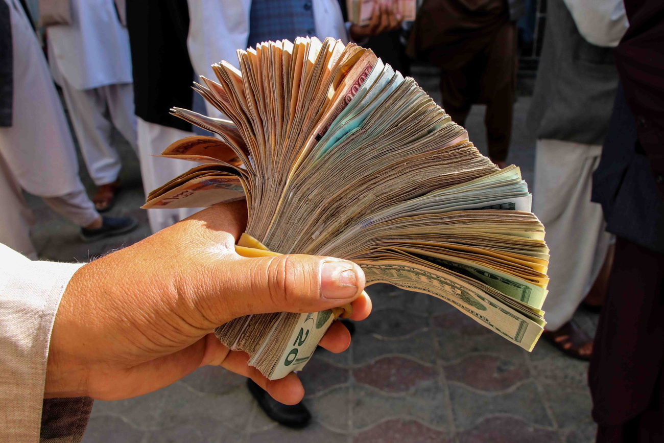 Currency dealer holding a wad of bank notes in Kabul, Afghanistan