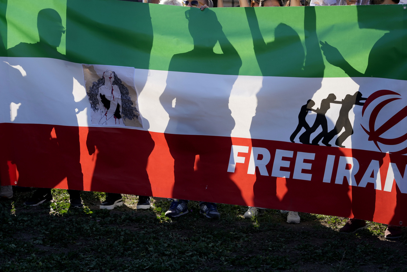 Protesters behind an Iranian flag