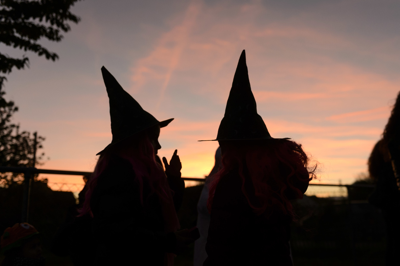 silhouettes of people with witch hats
