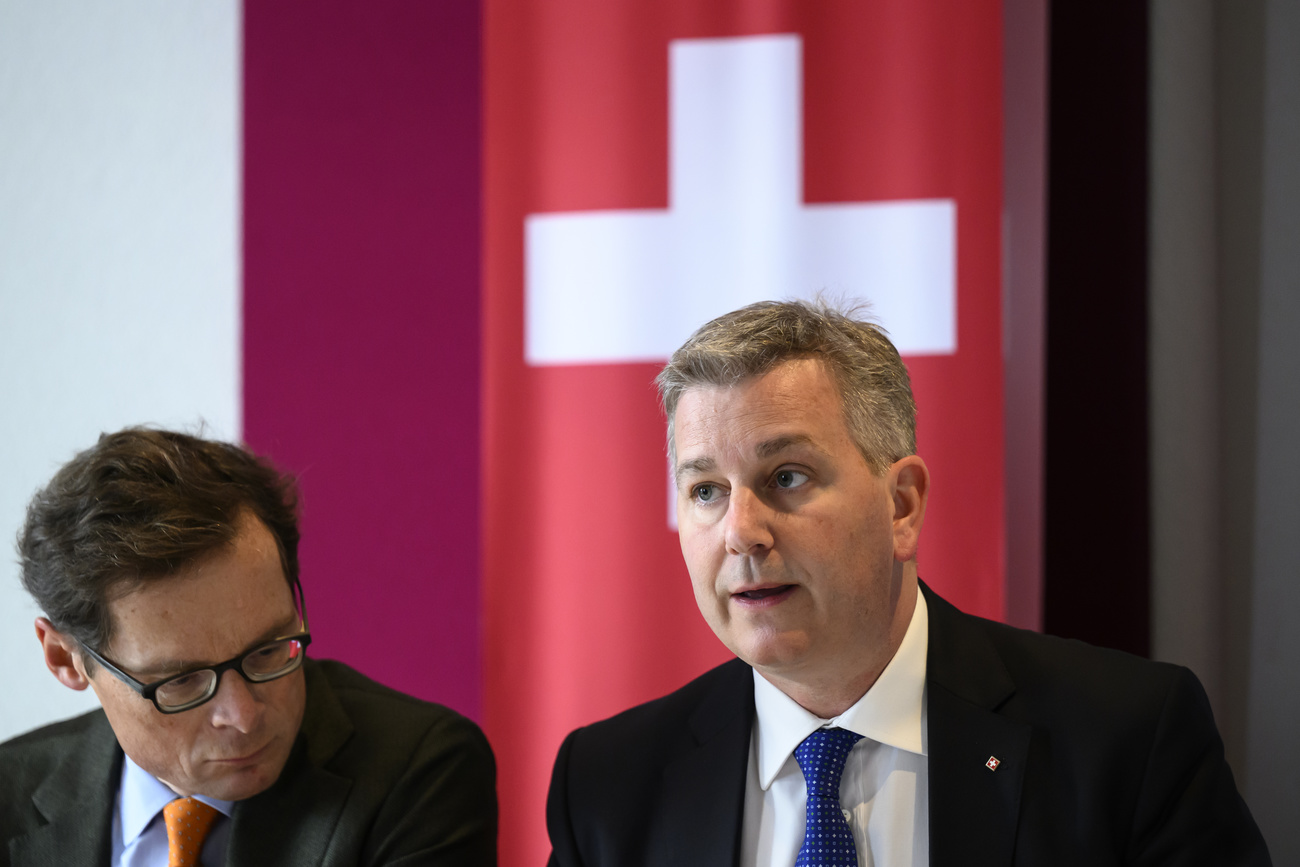 Two politicians and a Swiss flag