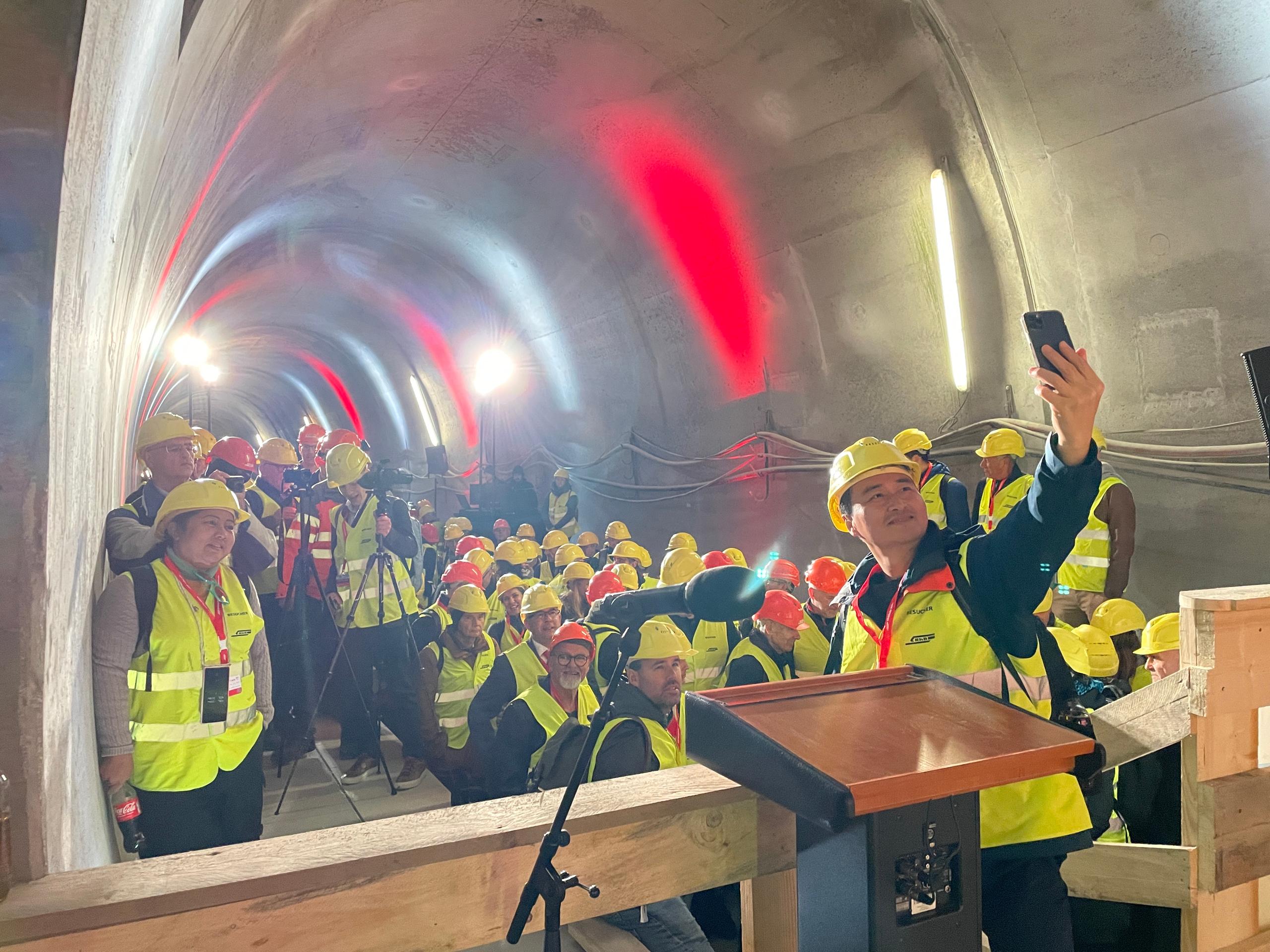 People wearing protective helmets and vests inside the Albula tunnel