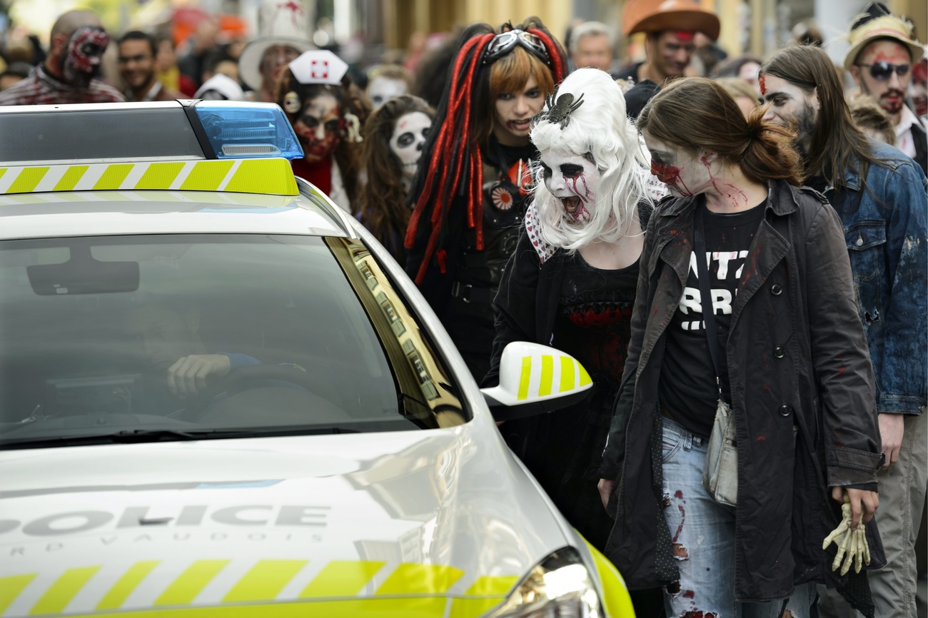 People dressed up as zombies and a police car