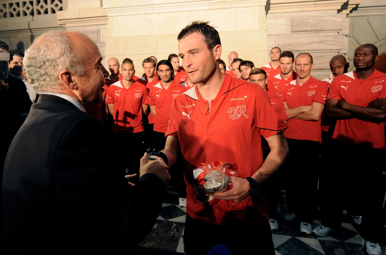 man in suit meeting Swiss footballers