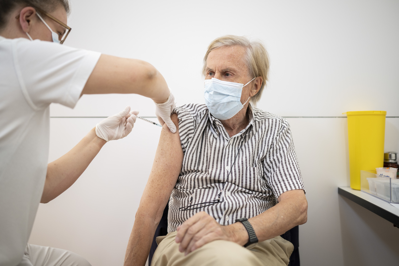 elderly person receiving booster shot