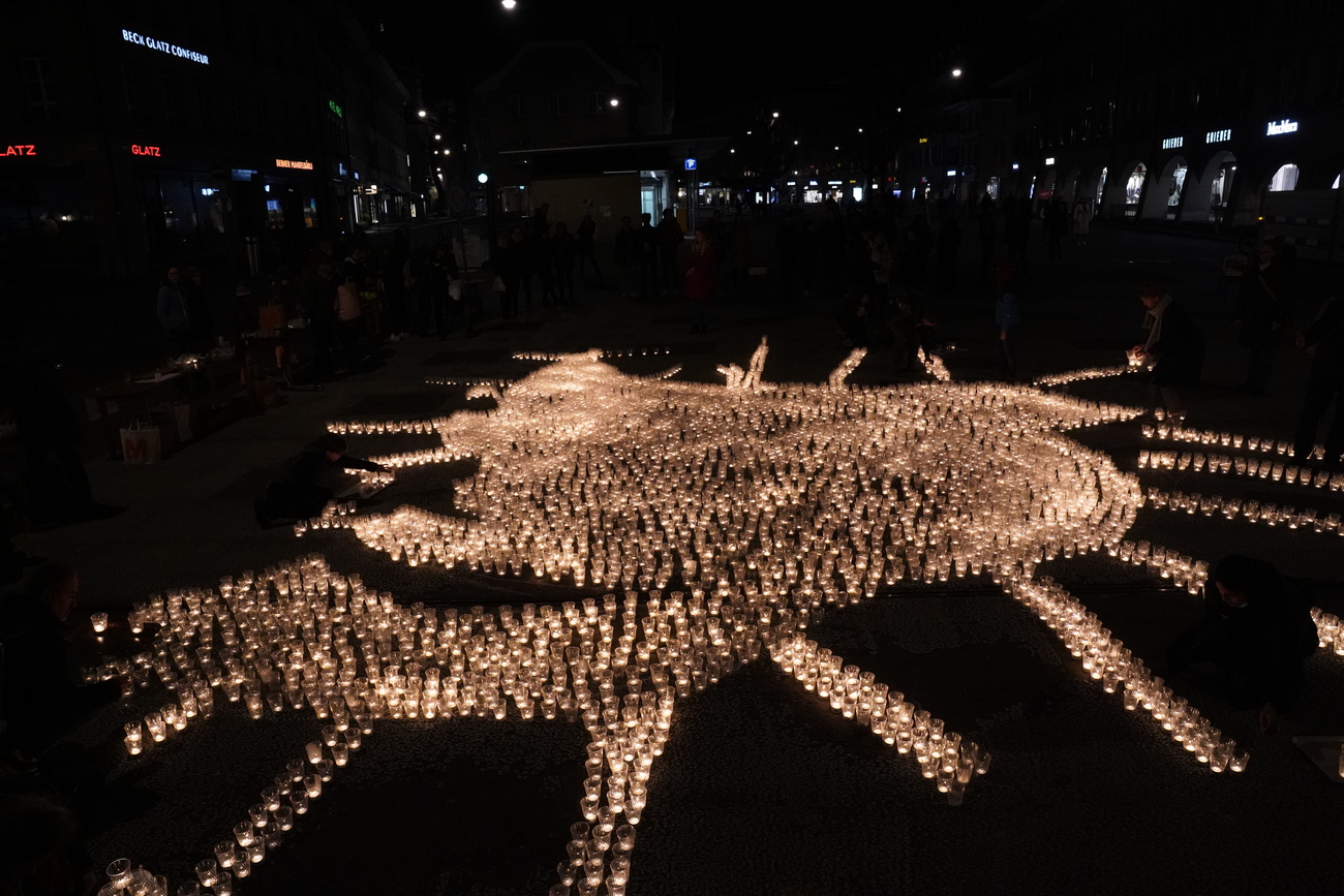 Thousands of candles on a dark plaza
