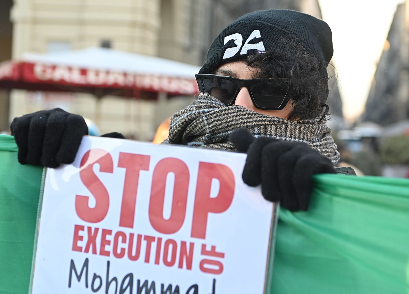 Person in Italy holding sign for Iran to stop executions