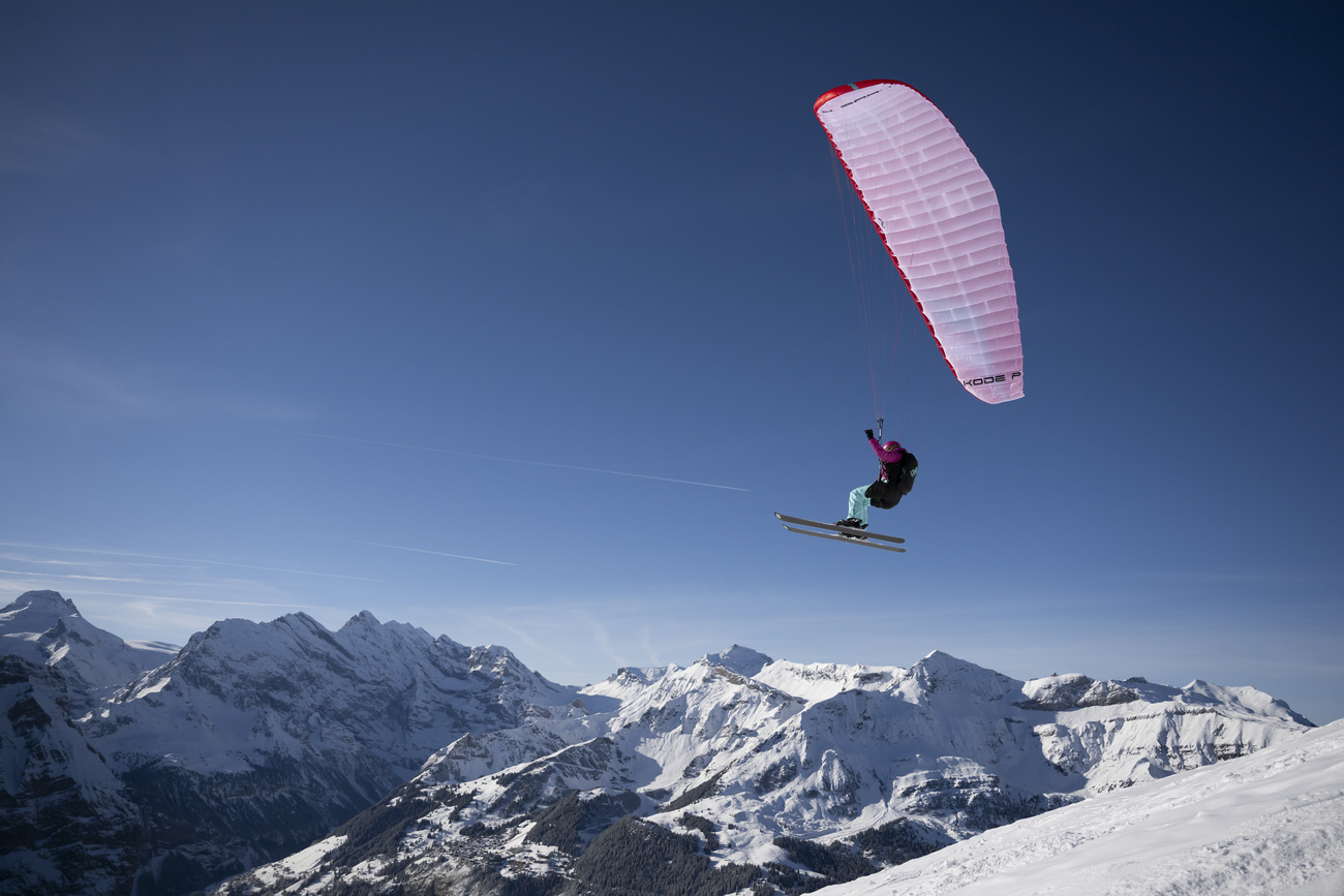 Man paragliding in skiis.