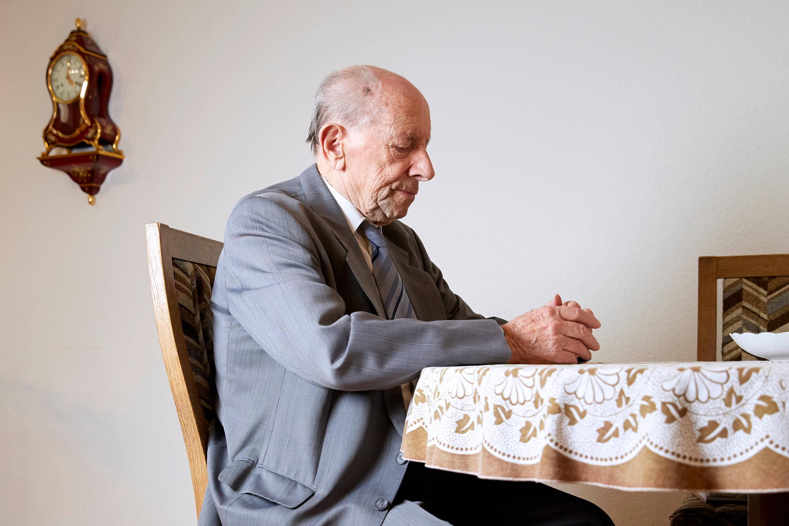 Old man sitting on a table