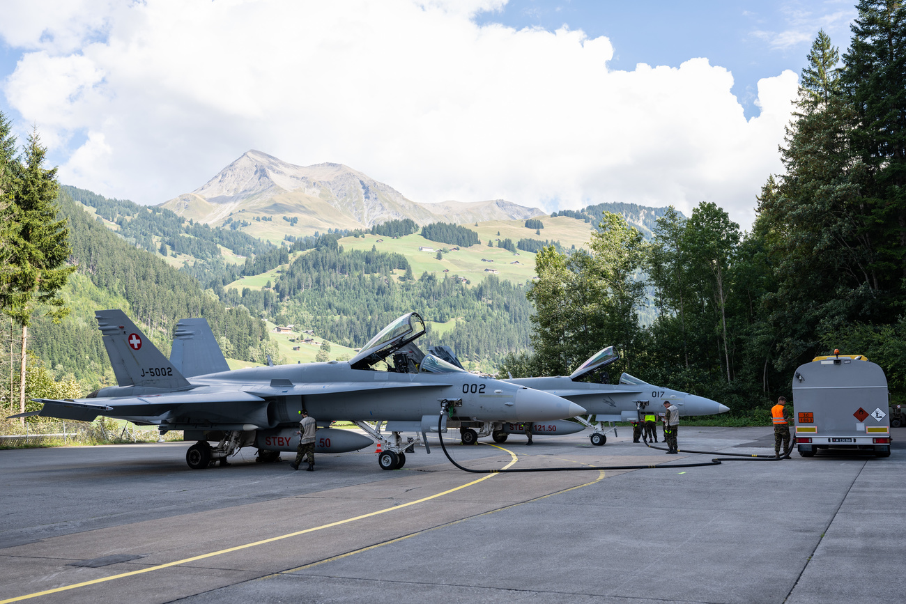 airplanes parked in front of mountains