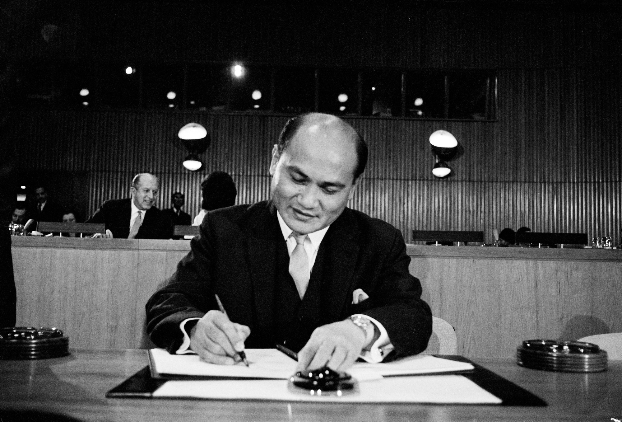 Ambassador Salvador P. Lopez (Philippines) is seen signing the Covenants.