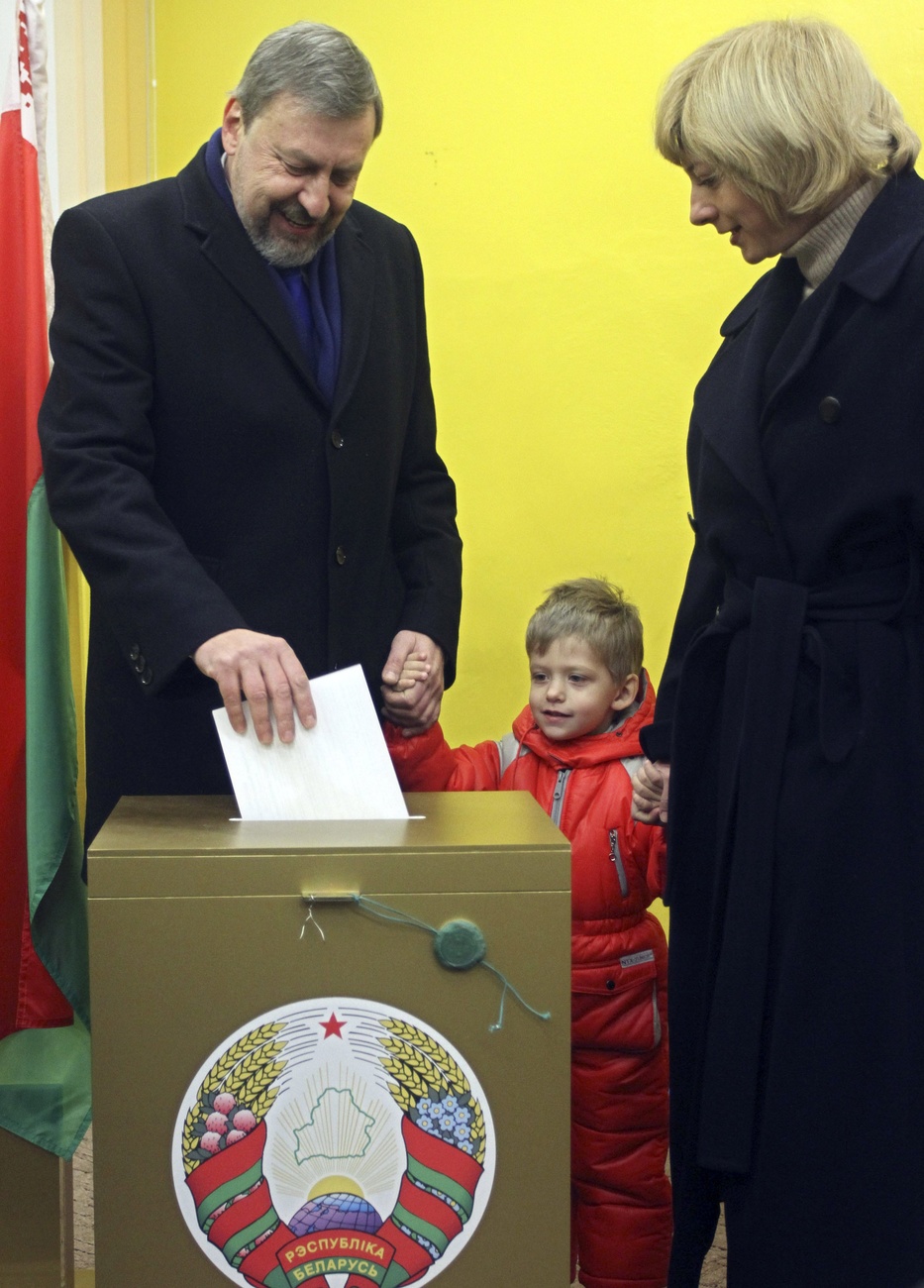 Sannikov dépose un bulletin dans une urne, avec sa famille