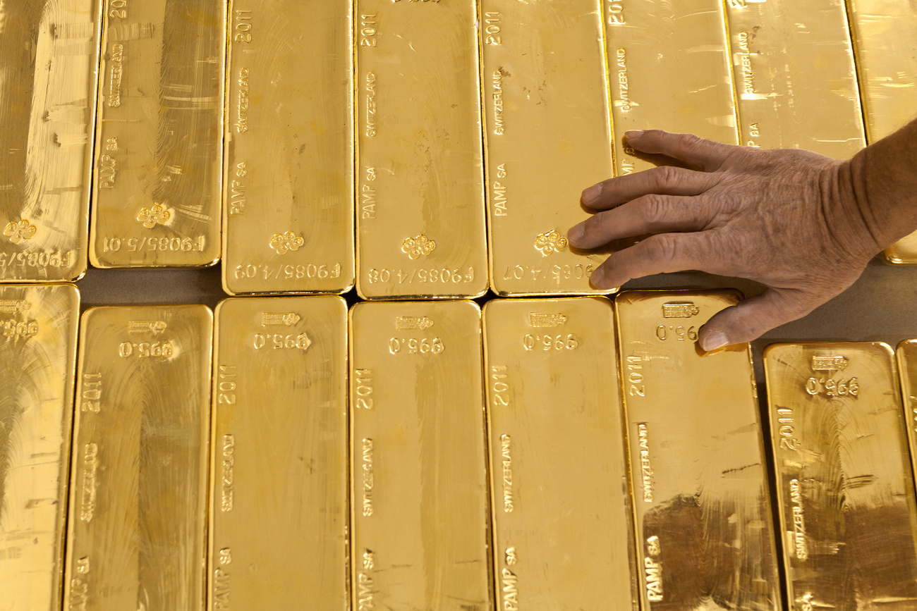 gold bars with hand