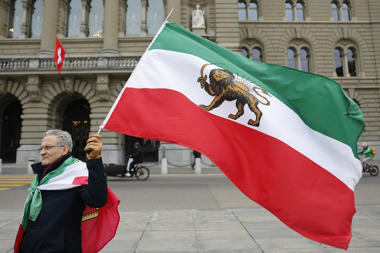 Demonstator with Iranian flag outside Swiss parliament building