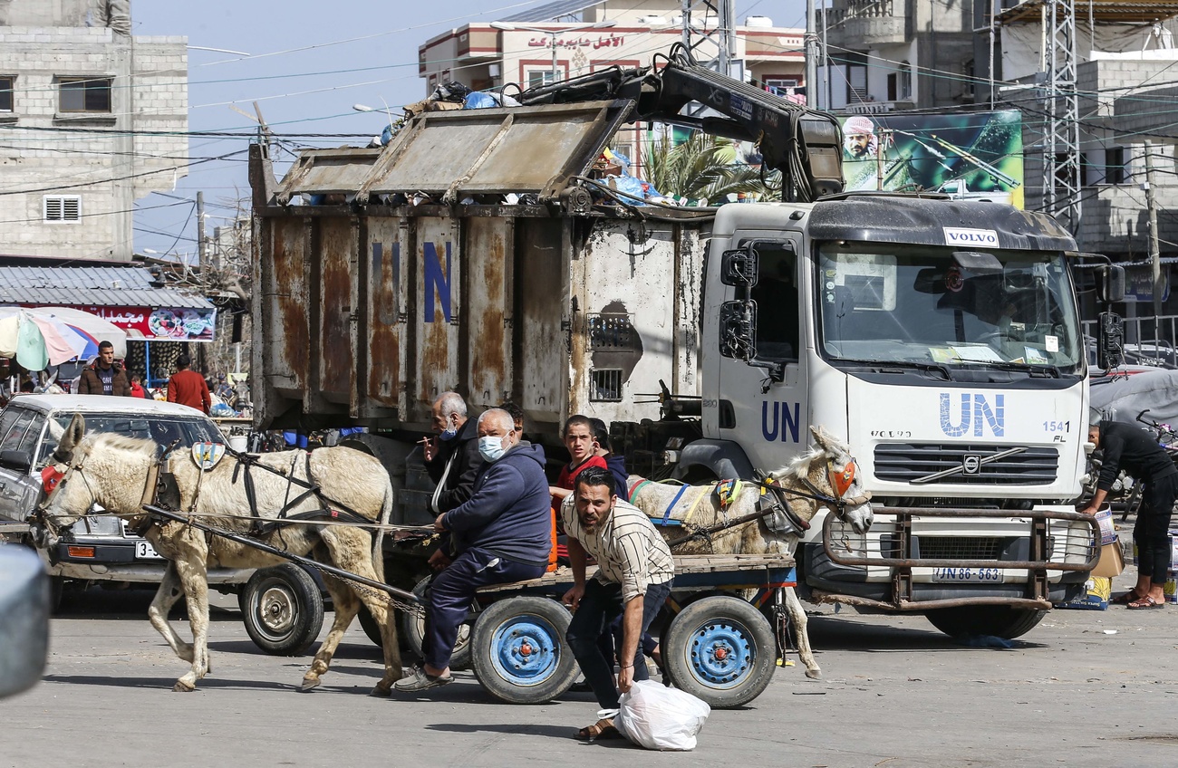 (UNRWA) workers clean a street at the Rafah refugee camp in the southern Gaza