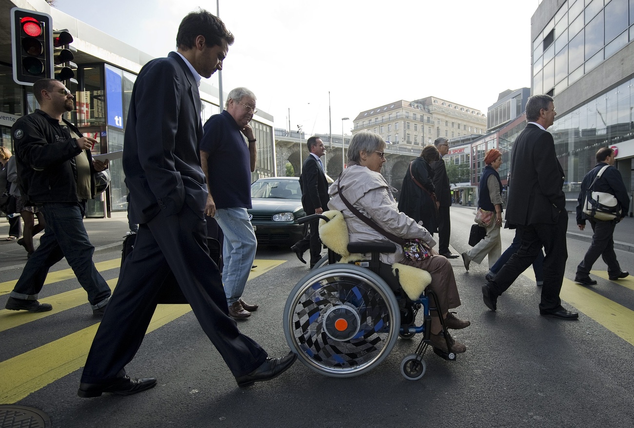 Person in wheelchair at a pedestrian crossing