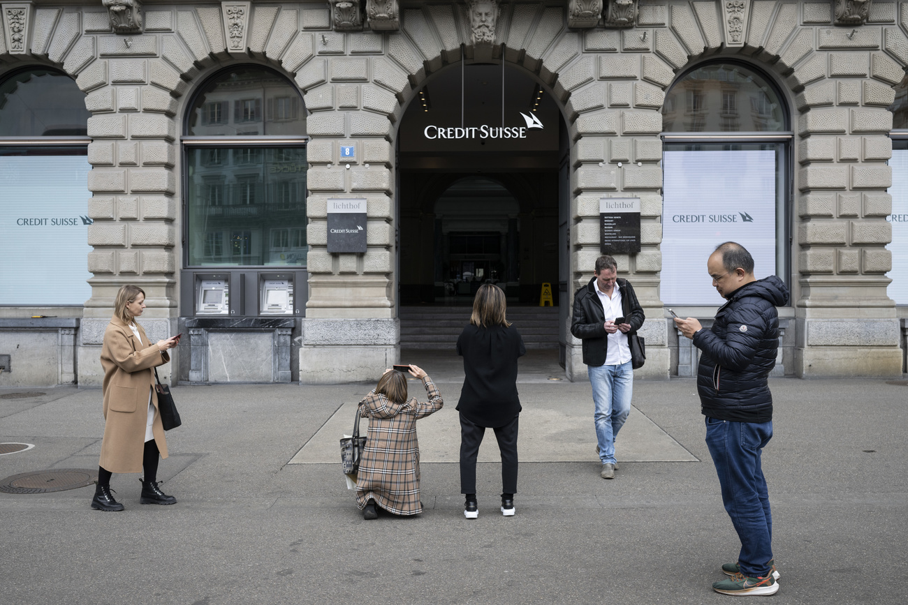 People taking pictures of a Credit Suisse bank branch